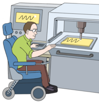 Ein Mann im Rollstuhl arbeitet an einem Laser. Er programmiert den Laser mit dem PC.